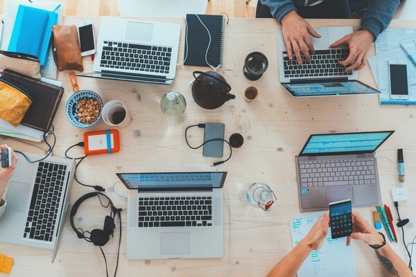 working on laptops together at desk